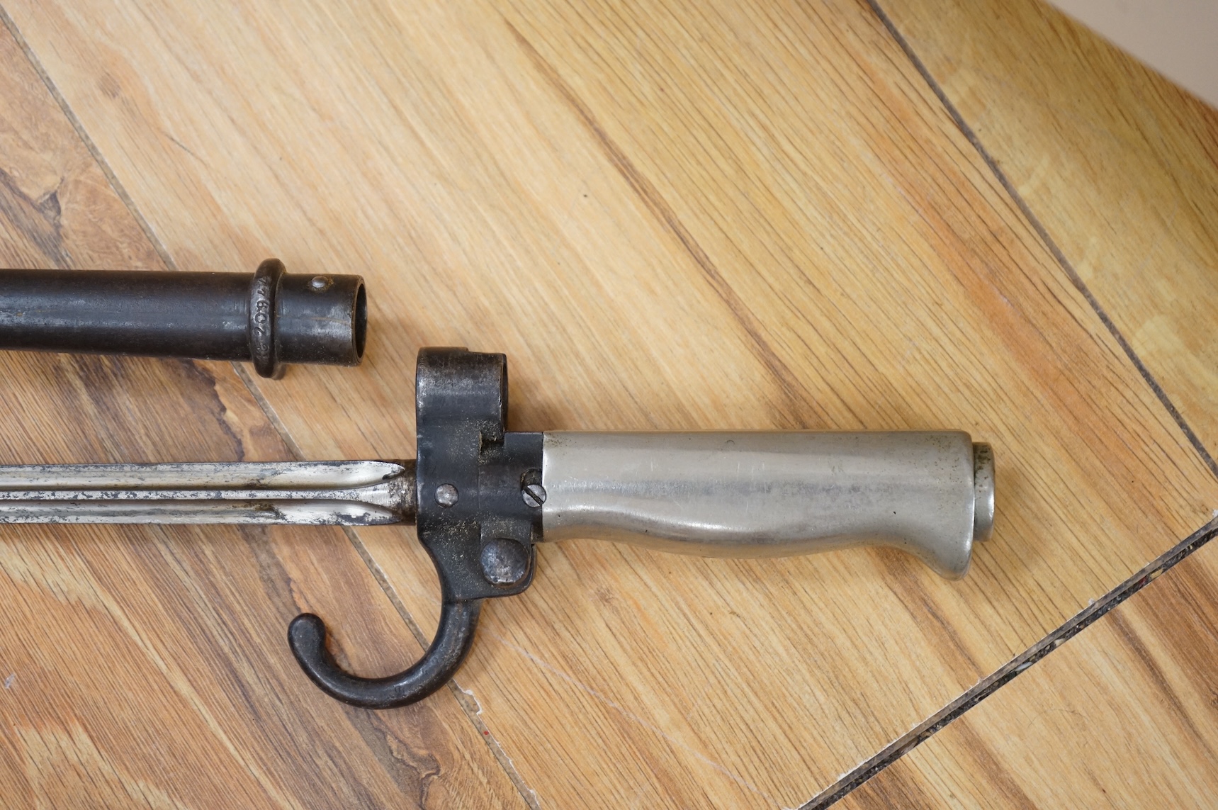 Three bayonets; a gras bayonet, a Lebel bayonet and an Indian Enfield style triangular socket bayonet, all in the original scabbards